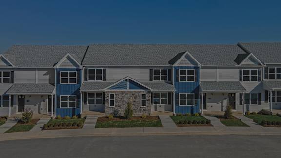 A row of houses with blue doors and windows.