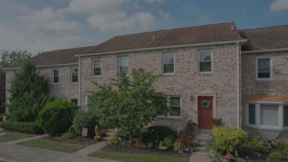 A house with a brown door and a red front door.
