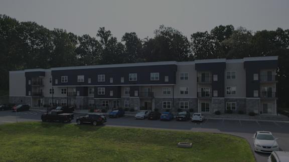 A building with a parking lot in front of it.