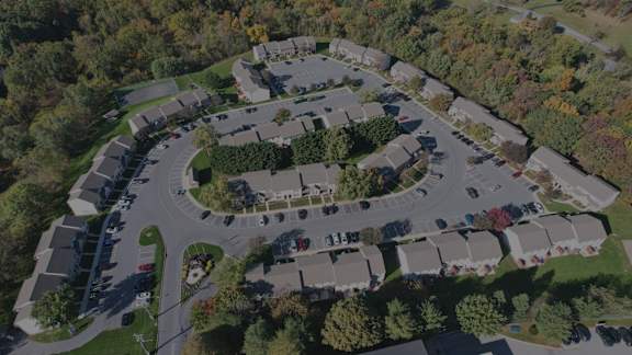 A bird's eye view of a residential area with houses and trees.