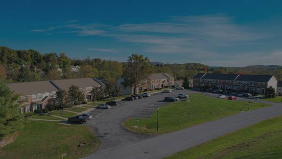 A residential area with houses and parked cars.