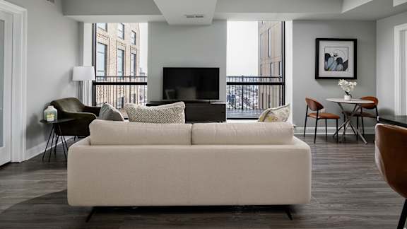 A living room with a white couch and a television.