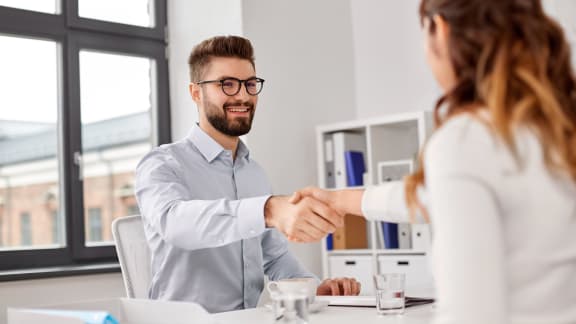 businessman shaking hands with a woman in an office at Yellowstone Landing, Belgrade, 59714