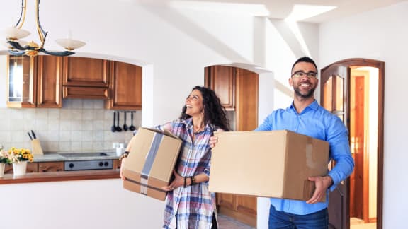 a man and woman holding boxes in a kitchen at Yellowstone Landing, Belgrade, 59714
