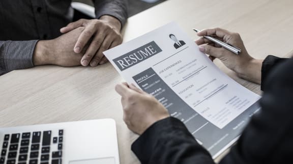 two people sitting at a table with a resume on a paper at Yellowstone Landing, Belgrade, 59714