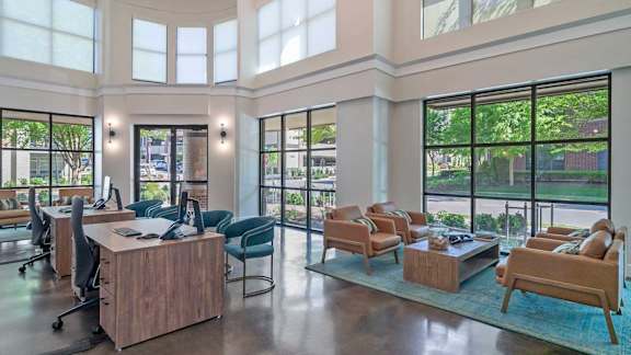 A modern office space with a large desk and chairs.
