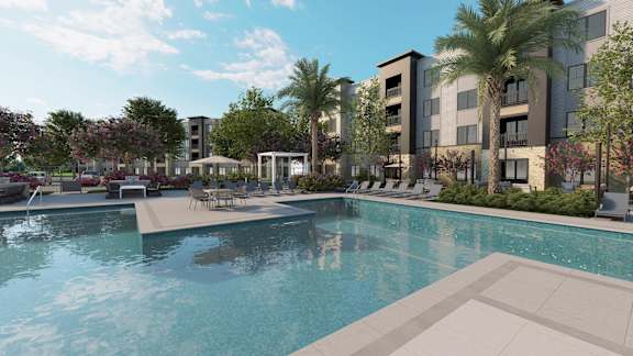 A swimming pool in front of apartment buildings.