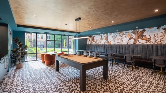 a large room with a pool table and chairs