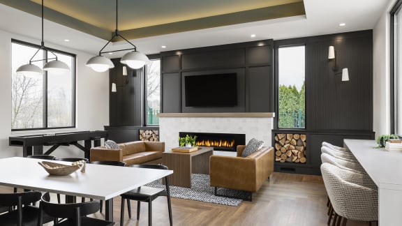 a living room with a fireplace and a table and chairs