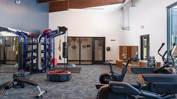 a gym with cardio machines and other exercise equipment at The Bosk Apartment Homes, Woodbury, Minnesota