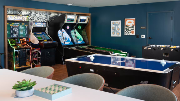 a gaming room with arcade games and tables