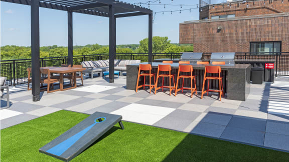 an outdoor patio with a bar and picnic table