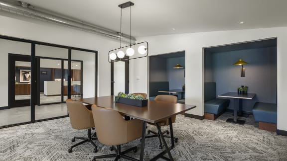 A conference room with a long table and chairs at The Bosk Apartment Homes, Minnesota 55125