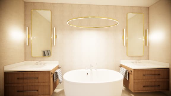 A bathroom with a white tub and wooden cabinets.