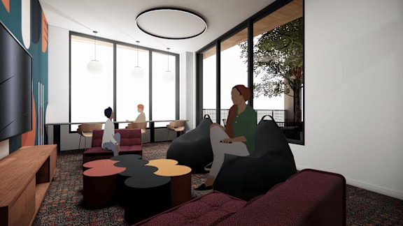 A modern living room with a person sitting on a bean bag chair.