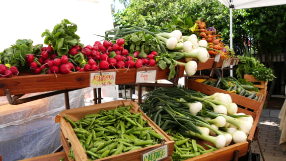 a variety of vegetables on display at a farmers market