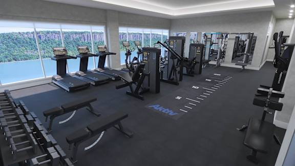 a gym with a view of the water in a condominium