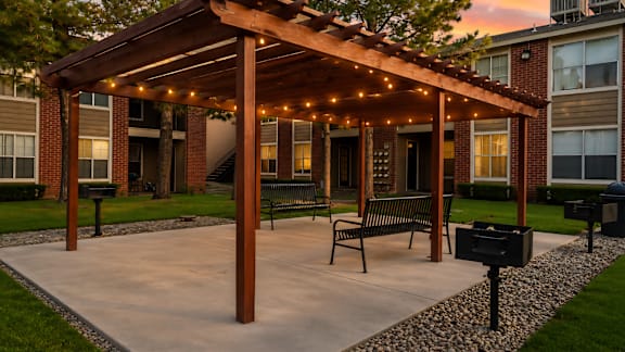 Outdoor pergola with string lights and seating at Las Lomas Apartments, El Paso, 79912