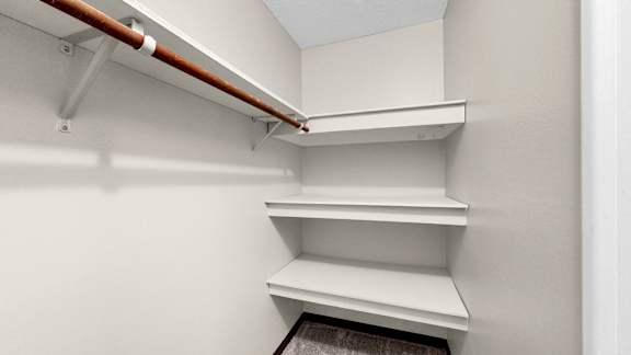 A white refrigerator with a brown handle.