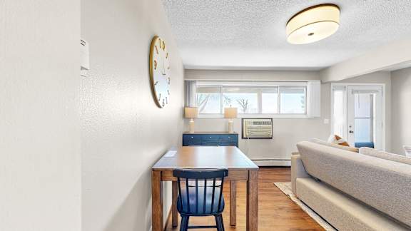 A dining room with a table and chairs is shown.
