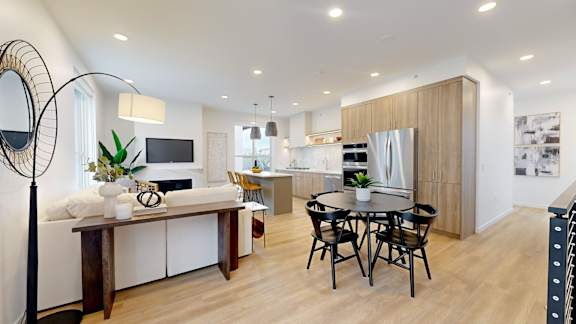 A modern kitchen with a dining table and chairs.