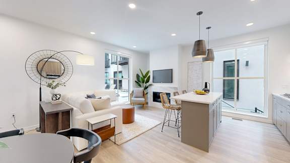 A modern living room with a grey table and a white sofa.
