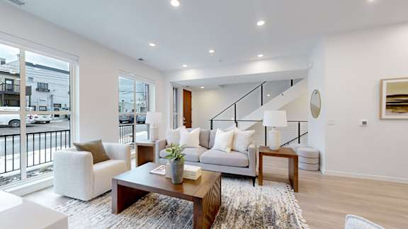 A living room with a couch, armchair, and coffee table.