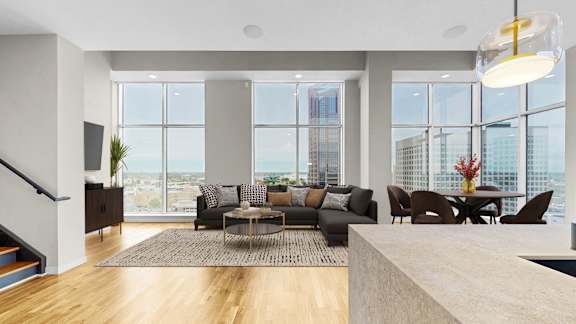 A modern living room with a large window overlooking the city.