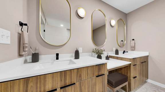 A bathroom with two sinks and two mirrors.