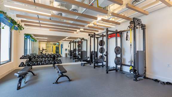 a fitness room with weights and other gym equipment