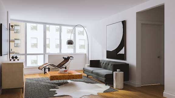 A modern living room with a grey couch, a wooden coffee table, and a large abstract painting on the wall.at 'The Metropolis', New York