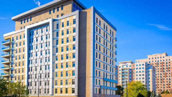 a large apartment building with a blue sky in the background