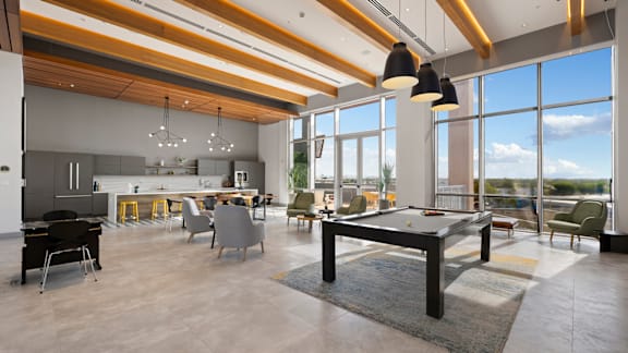 A modern open-plan living space with a pool table in the center.
