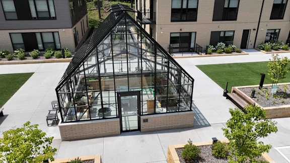 an aerial view of a greenhouse on the side of a building