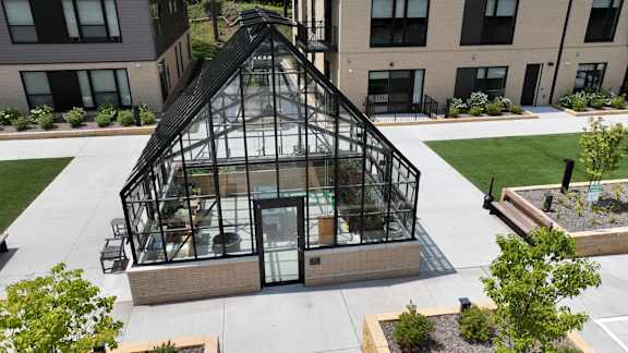 an aerial view of a greenhouse on the side of a building