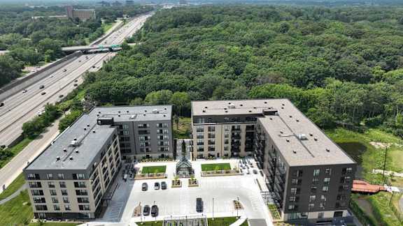an aerial view of a group of buildings and a highway