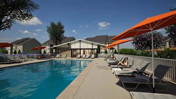 a swimming pool with chairs and umbrellas next to a house