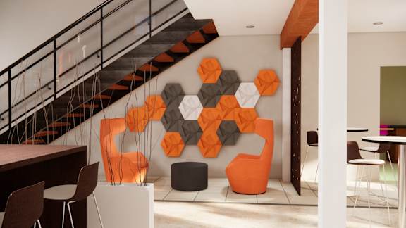 A modern living room with a staircase and a large orange and black geometric wall art.