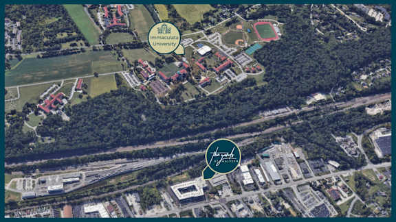 An aerial view of a campus with a Unicamp logo and a The park of sciences logo.