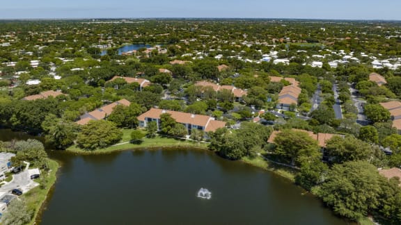 an aerial view of a neighborhood with a body of water