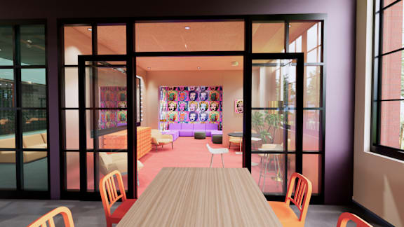 A room with a long table and chairs with a purple wall and a window. at University Commons in Pittsburgh, PA