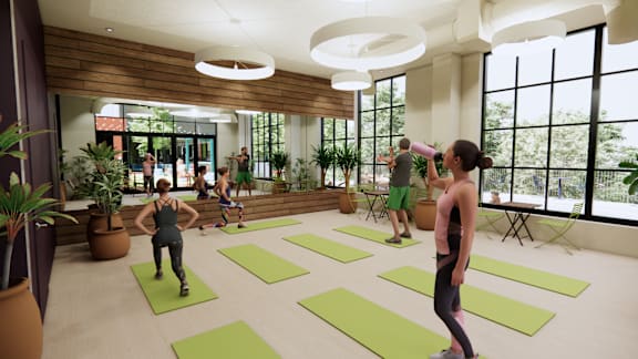 A group of people are exercising in a spacious room with yoga mats on the floor. at University Commons in Pittsburgh, PA
