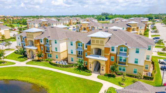 an aerial view of a large group of houses near a body of water