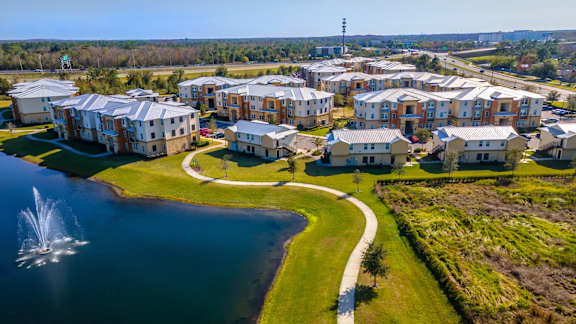 a group of houses in front of a body of water