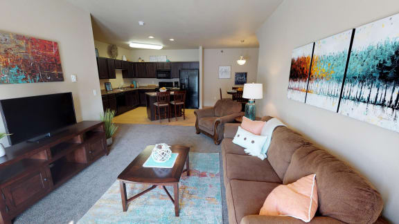 a bedroom with a bed and a dresser and a window at Stonebridge Villas Apartments, Minot