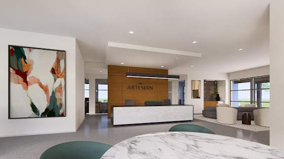 a reception area with a marble reception desk and a large painting