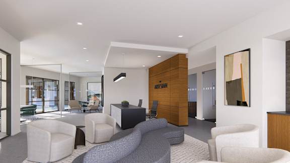 a living room with a couch and chairs and a desk