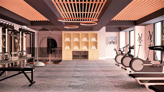 A modern gym with a variety of equipment including treadmills, stationary bikes, and weight machines.