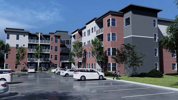 a rendering of a new apartment building in a parking lot