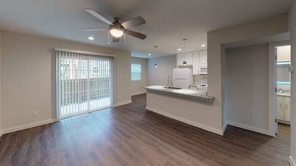 Spacious kitchen with a fan and patio access.